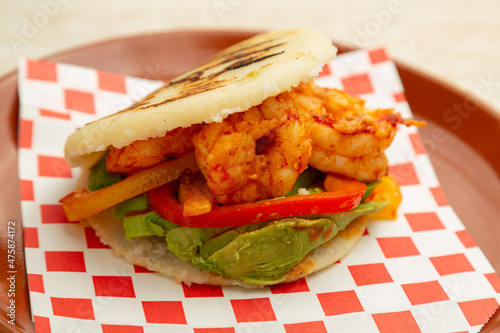 Latin American food Venezuelan Arepa with prawns and avocado.