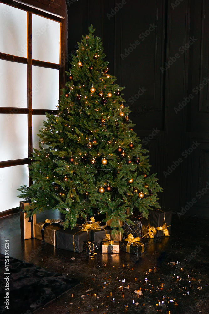 Classical Christmas decor. New year. Beautiful boxes with gifts near the tree. Dark background