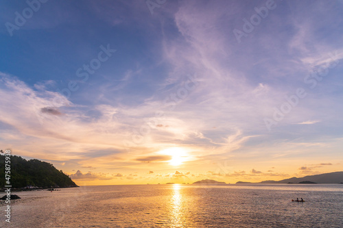 Beautiful gold sunset of reflection on sea wave with skyline background, summer twilight landscape