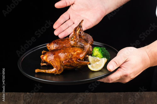 Traditional Cantonese roast pigeon on a and white porcelain plate