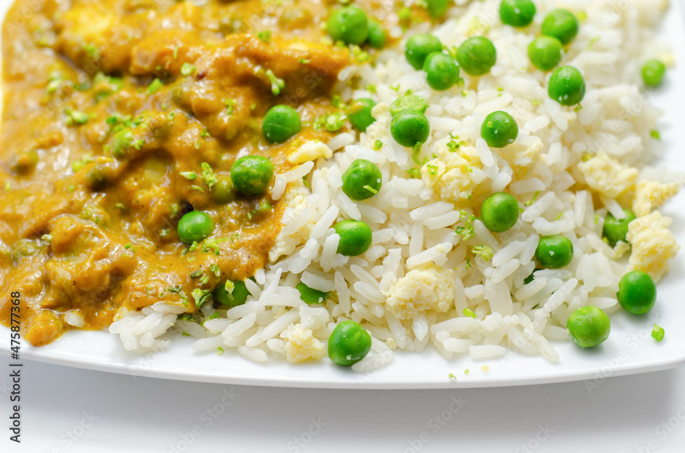 Chicken curry with egg fried rice, chicken breast pieces in a mildly spiced coconut curry sauce with fried rice with peas and egg