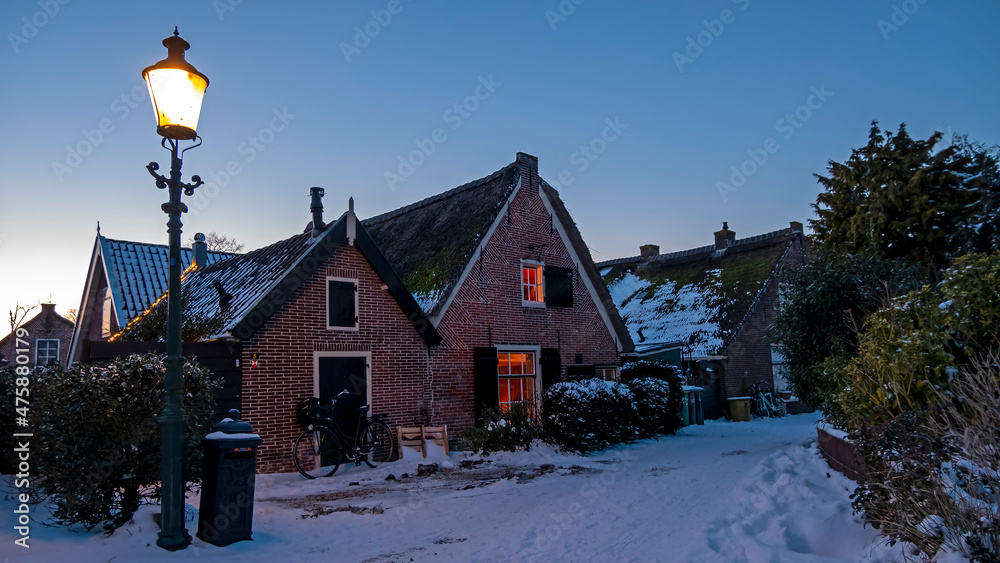 Snowy old traditional dutch houses in the countryside from the Netherlands in winter Snowy old traditional dutch houses in the countryside from the Netherlands in winter