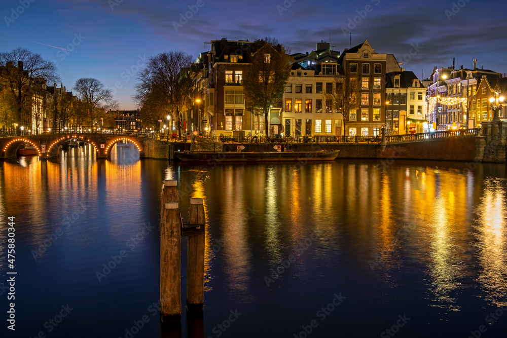 City scenic from Amsterdam at the river Amstel in the Netherlands at sunset