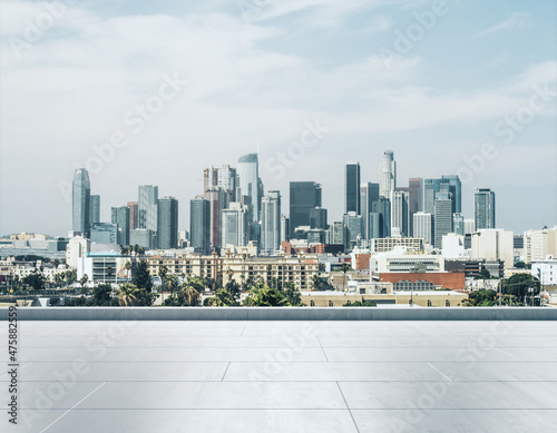 Empty concrete rooftop on the background of a beautiful Los Angeles city skyline at sunset, mock up © Pixels Hunter