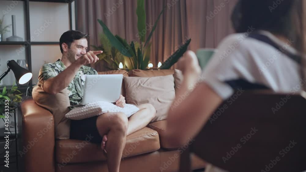 Asian caucasian just married couple in love conversation seated on couch in contemporary apartments, concept of capture happy moment, harmonic relationships, care and sincere feelings stay home relax Asian caucasian just married couple in love conversation seated on couch in contemporary apartments, concept of capture happy moment, harmonic relationships, care and sincere feelings stay home relax