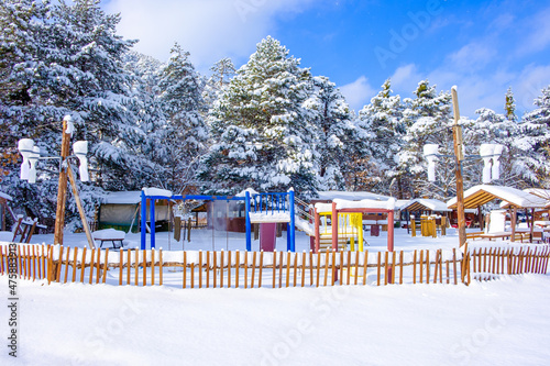 Snow covered huts and park