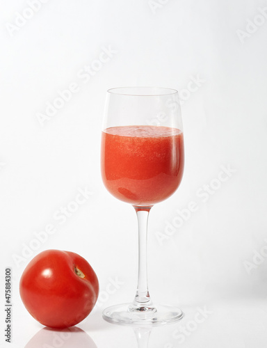 freshly squeezed tomato juice in a glass and tomato