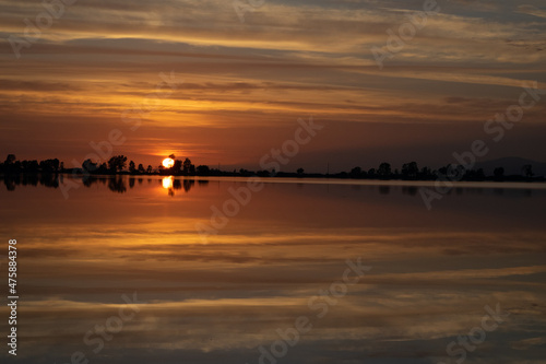 Sunset landscape over saltpans at Mesolonghi lagoon in Greece photo