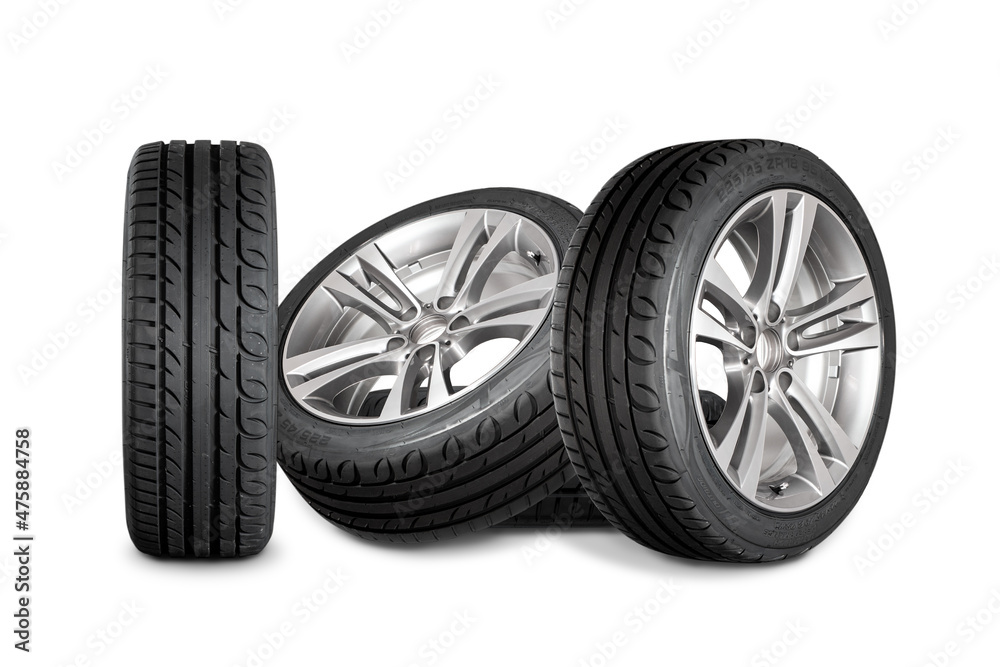 Set of four wheels on white background. New tires on aluminum wheel rims.