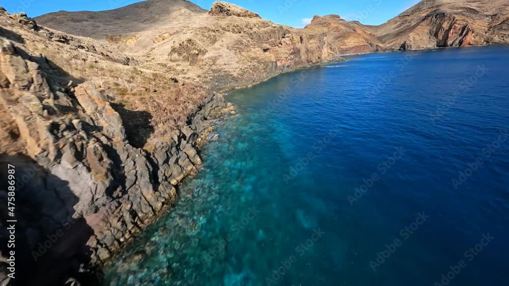 FPV racing drone Mountain surfing, and cliff diving along the rocks. Epic mountain landscape and ocean on Madeira island in Portugal. Beautifull nature. FPV racing drone Mountain surfing, and cliff diving along the rocks. Epic mountain landscape and ocean on Madeira island in Portugal. Beautifull nature.