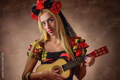 Gypsy woman wearing a traditional dress and playing charango photo
