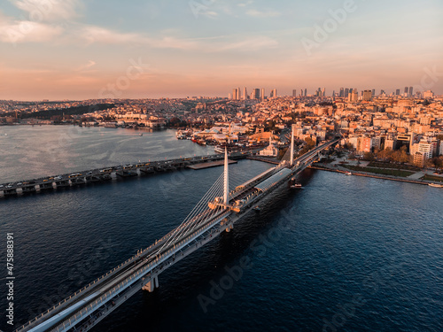  Drone shot of the Golden Horn Bridge in Istanbul. Cable-stayed bridge in Istanbul. A narrow curved bay that flows into the Bosphorus at its junction with the Sea of ​​Marmara. Metro line in Istanbul.