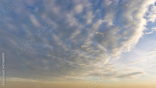 Beautiful view of sky with clouds at sunrise. Partly cloudy. Colorful sunset. Natural blue sky background texture, beautiful color.