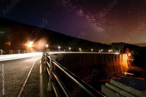 Cars driving over Arch on the dam wall at night with cars driving over in Hartbeespoort in the North West of South Africa photo