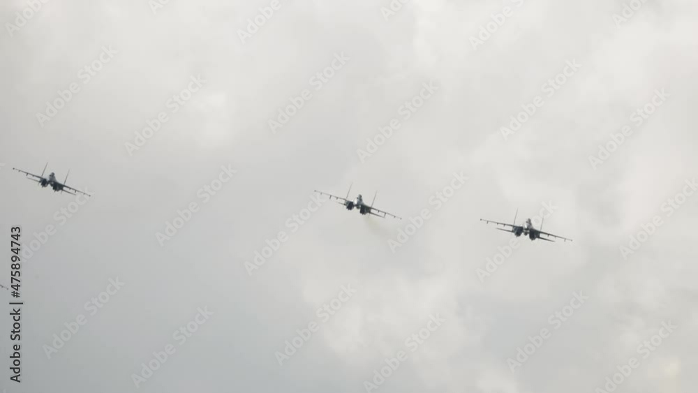 Supersonic fighter jets team in formation flying down. Military aviation. Russian jet military aircraft Flanker-E at airshow. Fighting falcon Supersonic fighter jets team in formation flying down. Military aviation. Russian jet military aircraft Flanker-E at airshow. Fighting falcon
