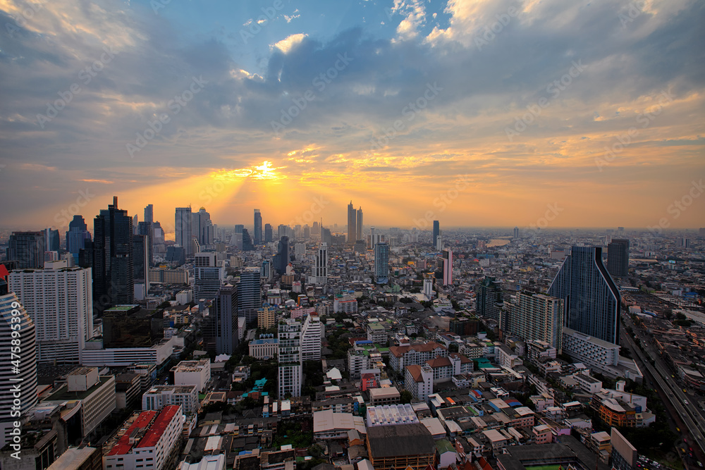 Fototapeta premium Aerial view of Bangkok modern office buildings, condominium, living place in Bangkok city downtown with sunset scenery, Bangkok is the most populated city in Southeast Asia.Bangkok , Thailand