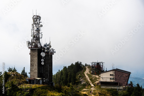 Telecommunication tower, radio relay and Black goat cable car (Telecabina Capra Neagra), Postavaru peak, Poiana Brasov, Romania. photo