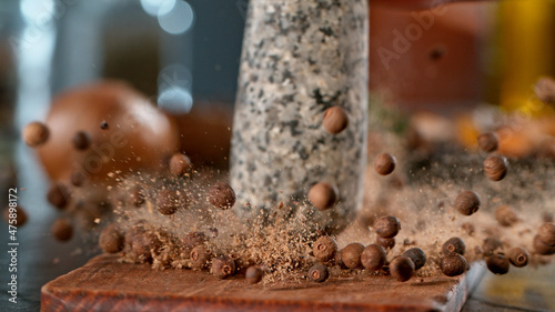 Tela Freeze motion of crushing allspice balls with mortar pestle