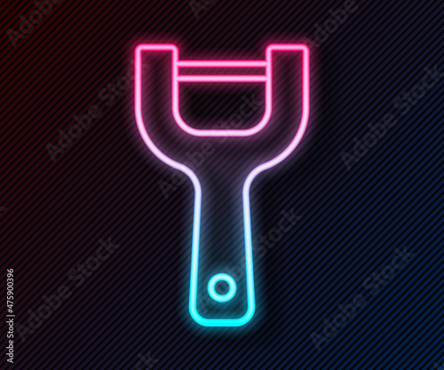 Glowing neon line Vegetable peeler icon isolated on black background. Knife for cleaning of vegetables. Kitchen item, appliance. Vector