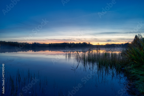 Colorful sunset on a small lake in autumn evening © Marko