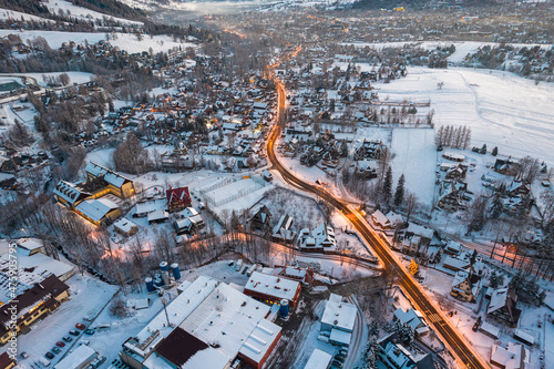 Fototapeta Naklejka Na Ścianę i Meble -  Snow in Zakopane at Winter. Aerial Drone Cityscape at Sunrise
