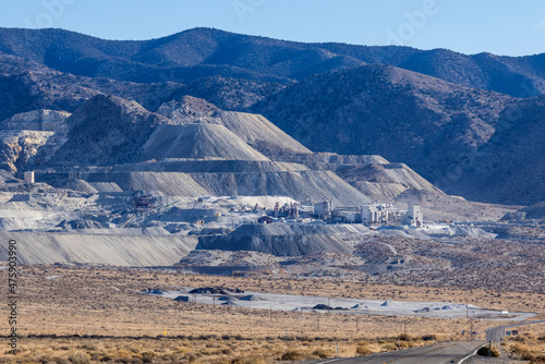 Industrial buildings built next to large tailing piles on a mountain in Gabbs Nevada