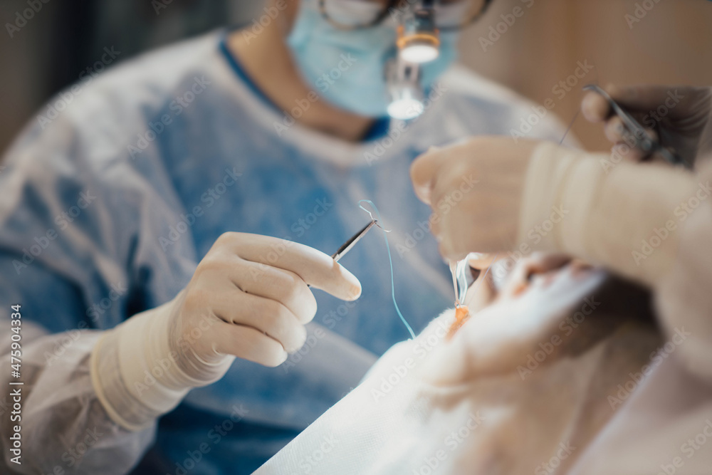 hands of a surgeon with surgical instruments, work with an assistant in the operating room. hands of a surgeon with surgical instruments, work with an assistant in the operating room.