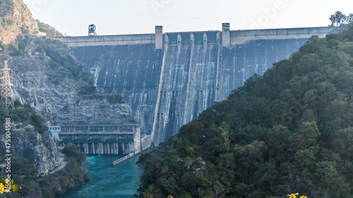 Bhakra Dam is a concrete gravity dam on the Sutlej River in Bilaspur, Himachal Pradesh in northern India. The dam forms the Gobind Sagar reservoir. photo