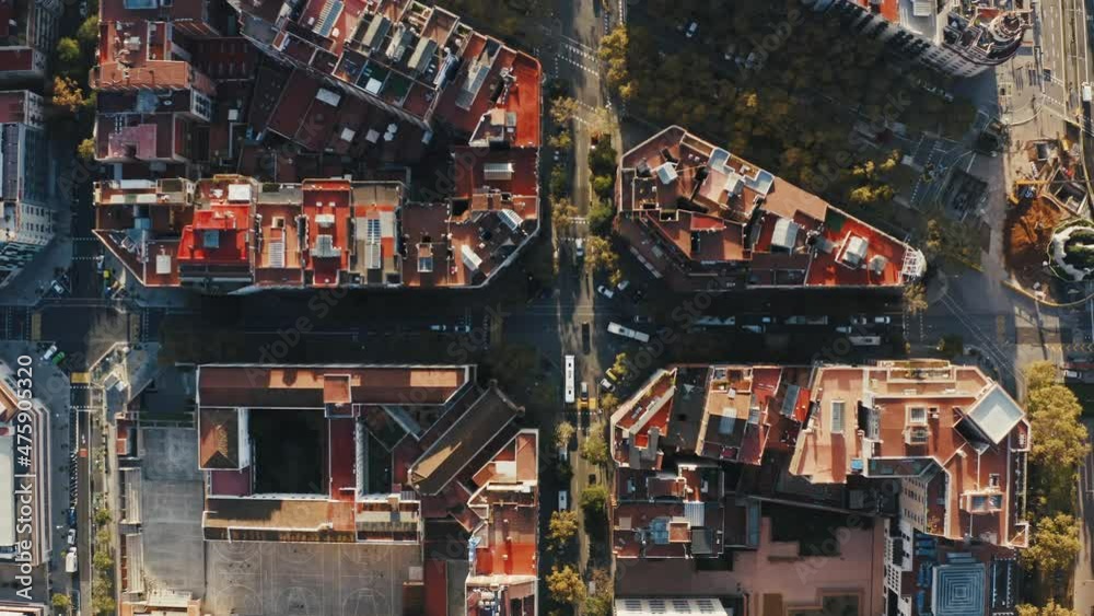 Aerial view of Barcelona city with typical urban buildings. Top-down shot over roofs, streets and blocks. Catalonia, Spain. Dolly shot Aerial view of Barcelona city with typical urban buildings. Top-down shot over roofs, streets and blocks. Catalonia, Spain. Dolly shot