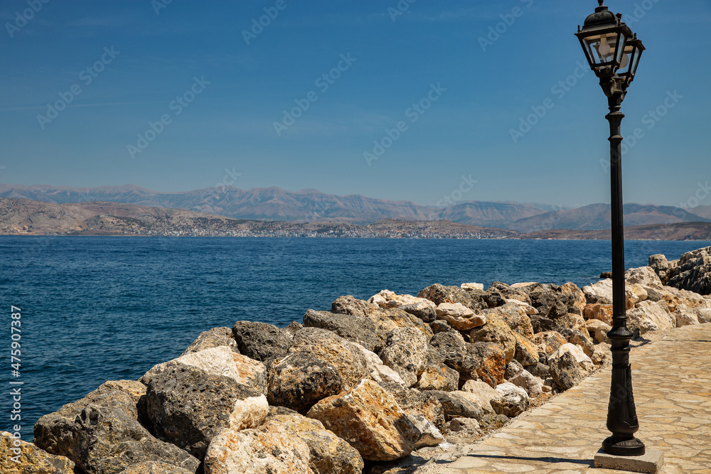 Street lamps on the waterfront in Kassiopi, Corfu island, Greece, - obrazy, fototapety, plakaty 