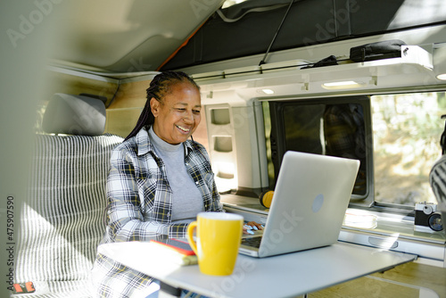 Black traveler browsing laptop during trip