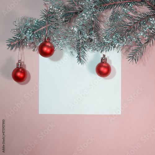 New Year or Christmas card, poster, advertising poster, announcement. Branches of fresh green spruce decorated with Christmas red balls. Free space for text.
