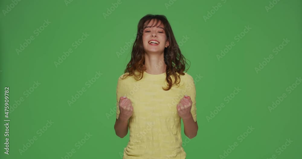 Overjoyed young girl make yes winner gesture, jumping, gesturing feel ecstatic triumph win on chromakey background Overjoyed young girl make yes winner gesture, jumping, gesturing feel ecstatic triumph win on chromakey background