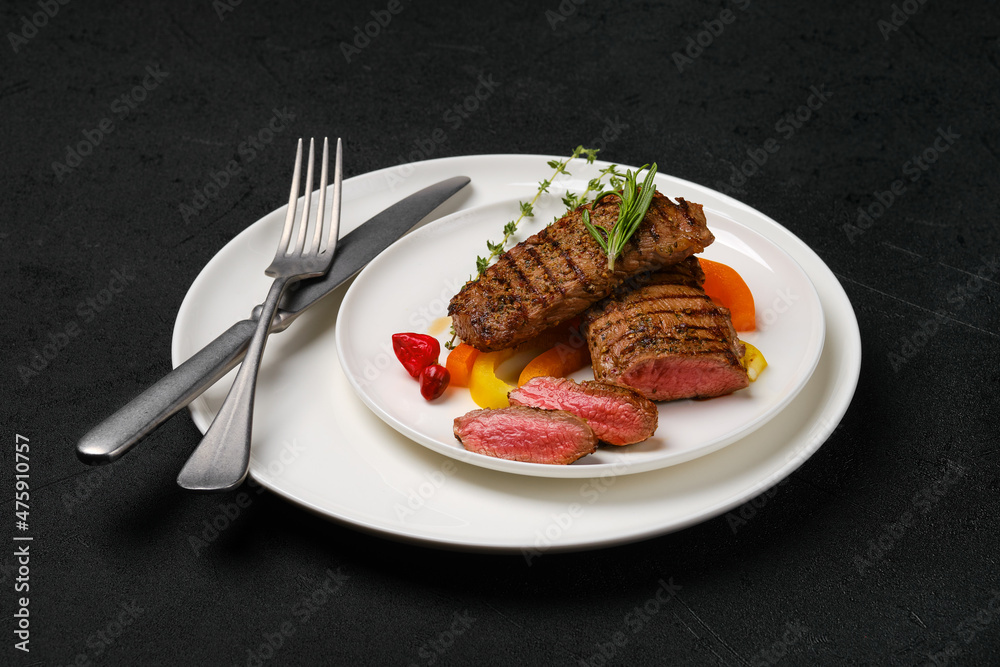 Grilled steaks cut on slices on a plate Grilled steaks cut on slices on a plate