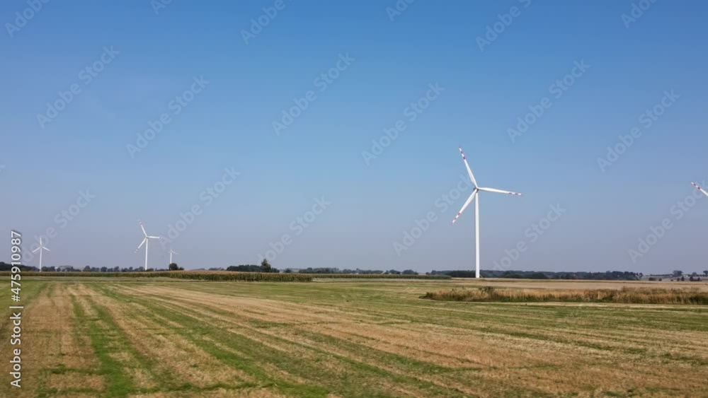 Alternative renewable energy concept, windmill turbines in the field. Aerial view of rotating windmill power generator Alternative renewable energy concept, windmill turbines in the field. Aerial view of rotating windmill power generator
