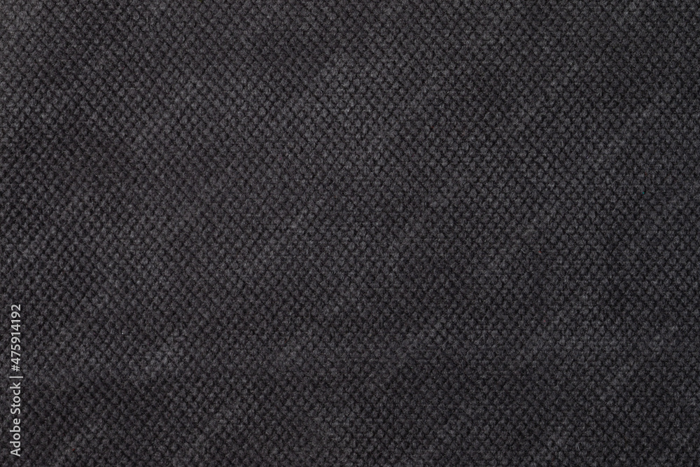 The texture of the fabric. Dark grey jacquard close-up. Soft expensive fabric for furniture, curtains, pillows and car upholstery. Background. A place to copy. The texture of the fabric. Dark grey jacquard close-up. Soft expensive fabric for furniture, curtains, pillows and car upholstery. Background. A place to copy.