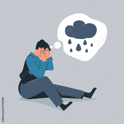 Unhappy man hugs his knees and sits on the floor with rainy cloud above his. Sad boy is crying. Male character feels depression, sorrow, grief. Mental disorder or illness concept. Vector illustration