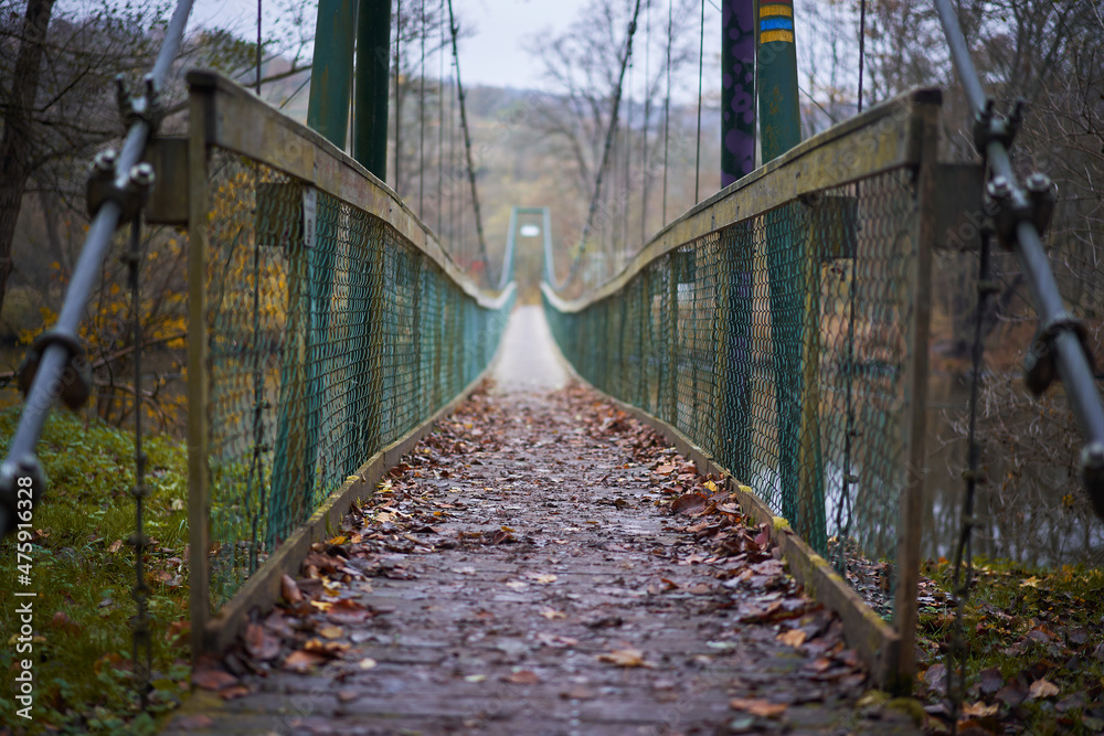 Fototapeta premium Rope bridge or cable bridge on the foot path over the river Dyje in southern moravian region of Czech republic in the beautiful historical vineyard coutryside close to austrian border ideal for hiking