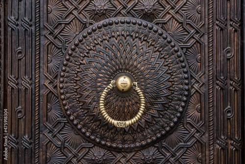 Closeup of a vintage old metal door with knocker