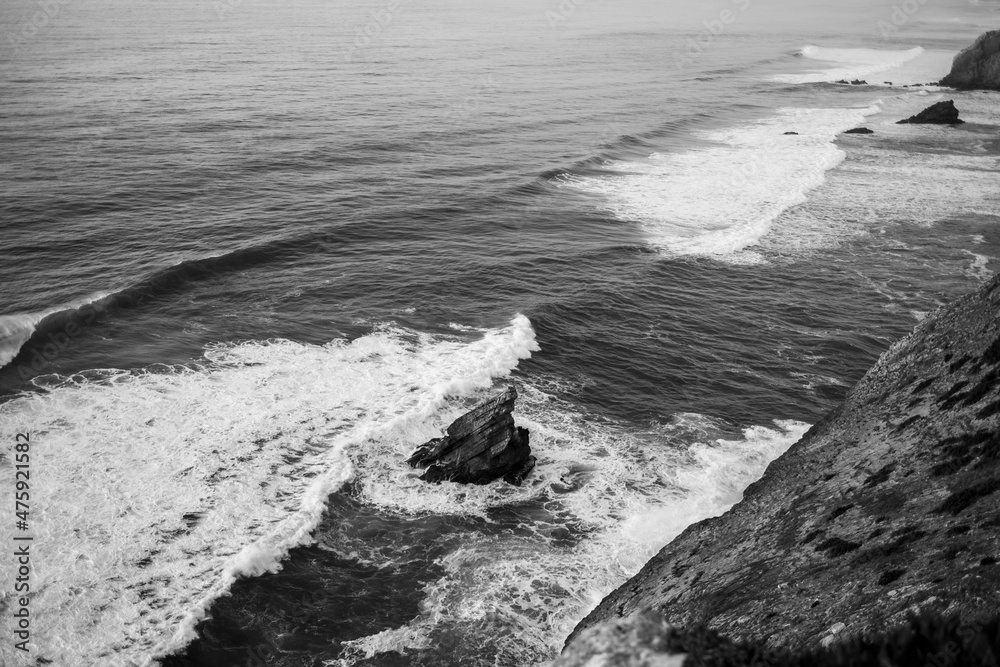 Ð¡liffs in the Atlantic Ocean, Portugal. Black and white photo.
