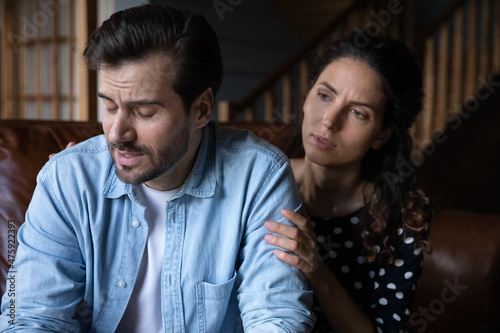 Unhappy young hispanic woman apologizing to stressed husband feeling guilty after quarrel or misunderstanding. Confused millennial man feeling offended, married couple having relations problems.