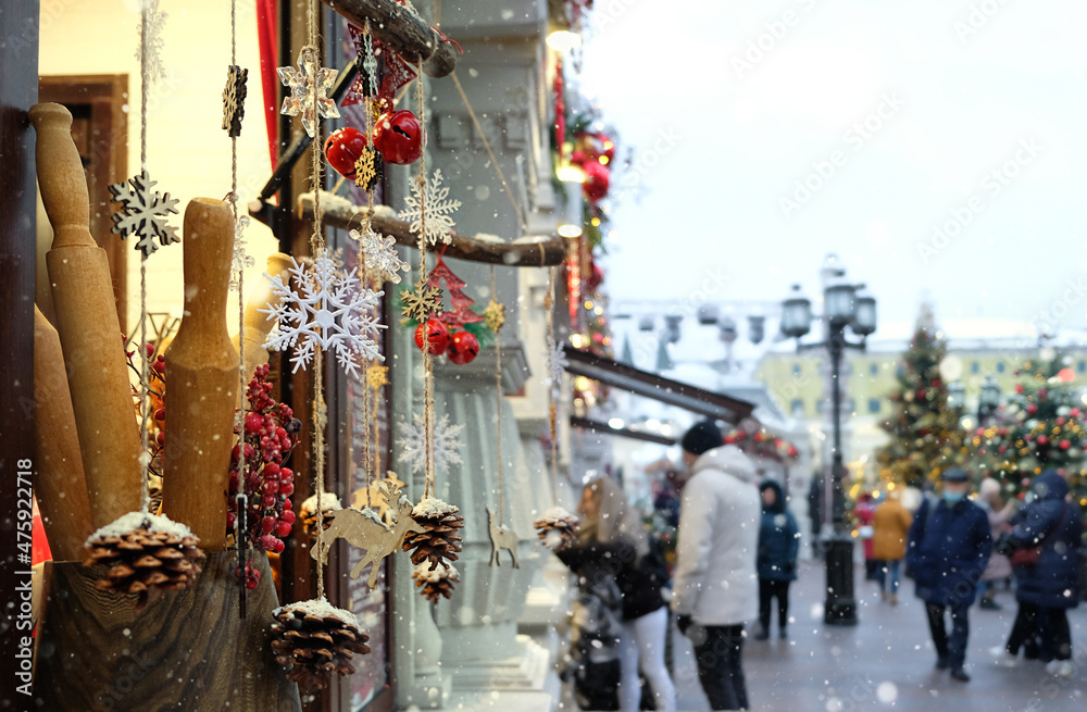 abstract blurred background with christmas market outdoor. unidentified people shopping at Christmas fair, gift shop. festive winter season. New year and Christmas holidays concept