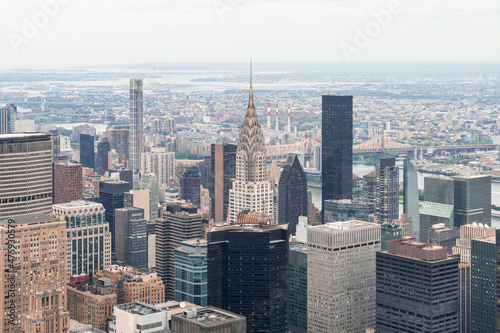 Zoom in aerial panoramic city view of Upper Manhattan area  the East Side  river and Brooklyn neighborhoods on horizon  New York city  USA. Iconic cityscape of building exteriors of NYC