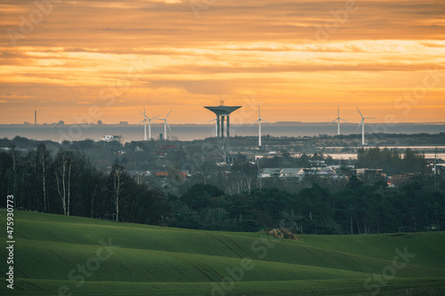 Rural countryside in Glumslov hills with water tower in Landskrona, Sweden. Captured close to sunset on a cold and foggy winter day in December. Selective focus. photo