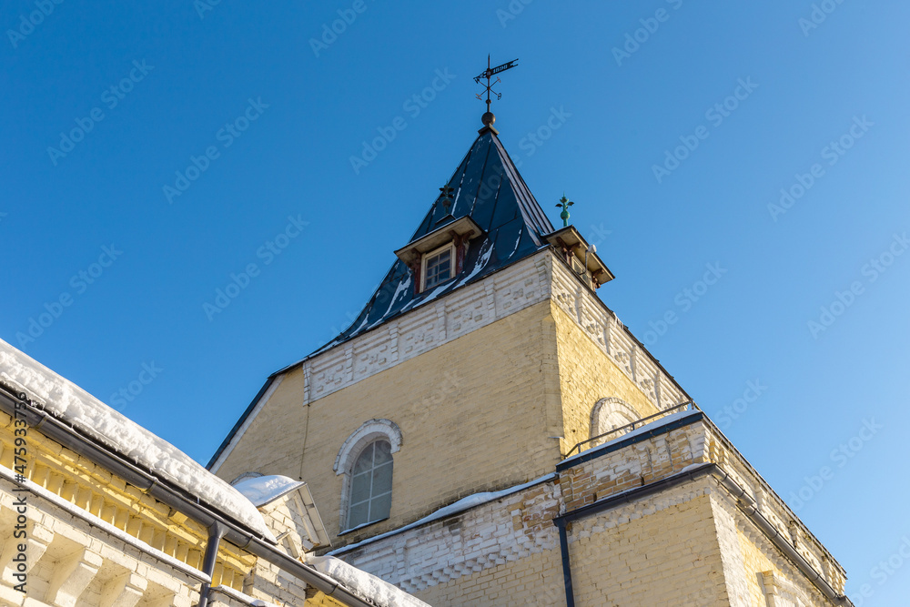 Classicism style building elements small tower, roof ledge covered with snow in winter time