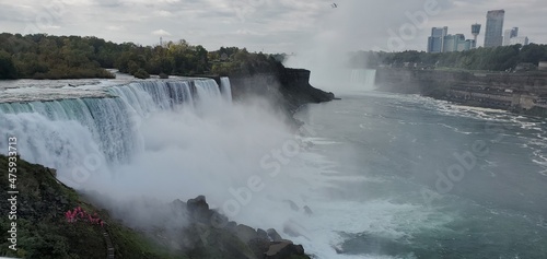 The steaming Niagra Falls, New York Below are the tourist wearing pink raincoats.
