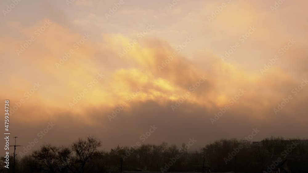Red, Fiery, Orange Sky at Dawn, Covered with Smoke from a Fire, Hiding Sun. A strong gust of wind drives dirty, hazy cumulus clouds of black smoke over roofs of old houses. Environmental pollution. Red, Fiery, Orange Sky at Dawn, Covered with Smoke from a Fire, Hiding Sun. A strong gust of wind drives dirty, hazy cumulus clouds of black smoke over roofs of old houses. Environmental pollution.