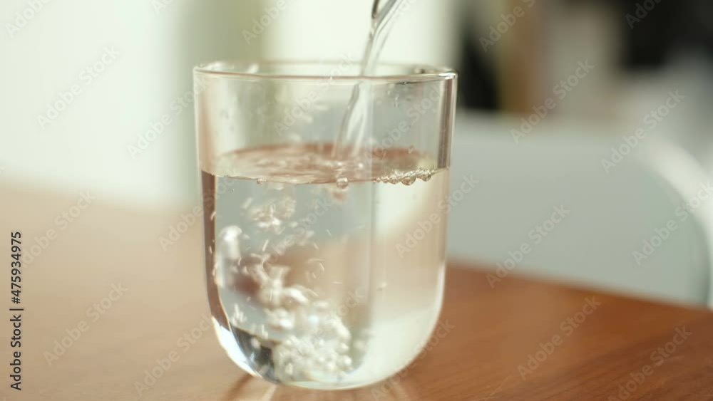 Man pouring mineral water glass before drinking it, health care lifestyle