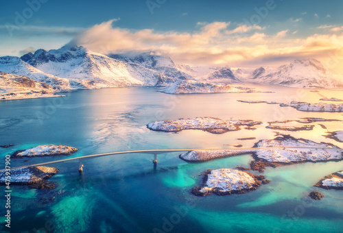 Billede på lærred Aerial view of bridge, small islands, blue sea and snowy mountains