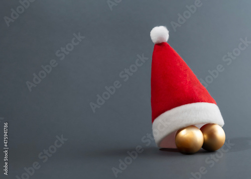 Ornaments under the Santas hat against blue gray livid background Fototapeta